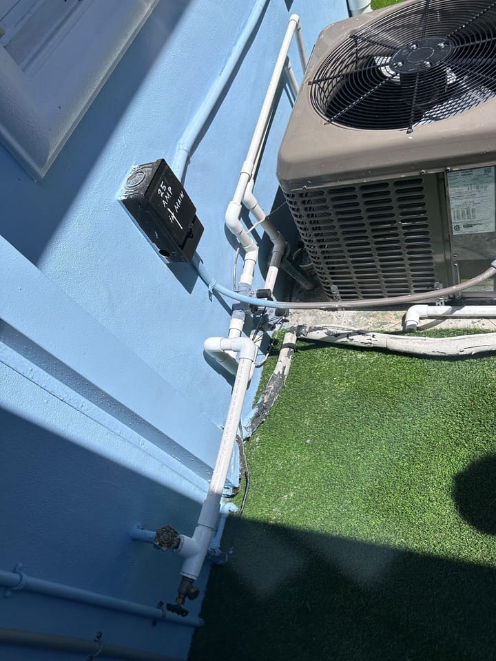 PVC irrigation piping along exterior wall